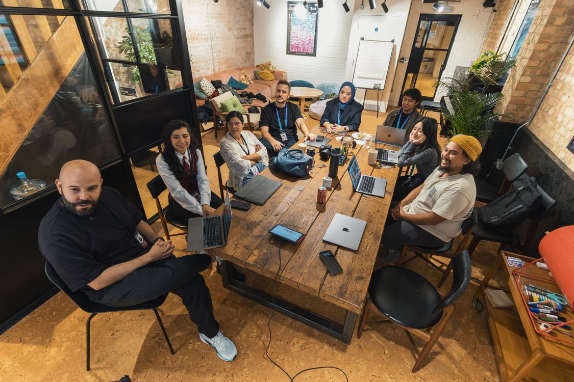 Diverse professional team meeting in a bright modern office discussing sustainable partnerships